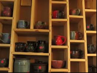 Mugs in a book case